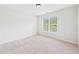 Bright bedroom with neutral carpeting and a window view at 7501 Montibillo Pkwy, Durham, NC 27713