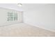Bright, vacant bedroom featuring neutral carpet, fresh paint and a large window at 7501 Montibillo Pkwy, Durham, NC 27713