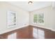 Cozy bedroom with wood floors and two windows providing natural light at 7501 Montibillo Pkwy, Durham, NC 27713
