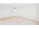 Bright vacant bedroom featuring neutral carpet, fresh paint, closet, and doorway to additional rooms at 7501 Montibillo Pkwy, Durham, NC 27713
