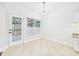 Bright breakfast nook with a door to the deck, large windows, and light tile floors at 7501 Montibillo Pkwy, Durham, NC 27713