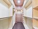 Walk-in closet with hardwood floors, ample shelving, and custom wood drawers at 7501 Montibillo Pkwy, Durham, NC 27713