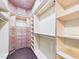 Custom walk-in closet featuring wood finishes and ample shelving space at 7501 Montibillo Pkwy, Durham, NC 27713