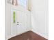 Bright entryway featuring a white door with sidelights, transom window, and gleaming hardwood floors at 7501 Montibillo Pkwy, Durham, NC 27713
