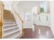 Grand foyer with hardwood floors, a staircase, and a large window at 7501 Montibillo Pkwy, Durham, NC 27713