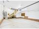 Large garage with access stairs and ample space for storage or vehicles, featuring brick foundation at 7501 Montibillo Pkwy, Durham, NC 27713