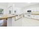 Bright kitchen featuring granite counters, white cabinets and tile flooring at 7501 Montibillo Pkwy, Durham, NC 27713