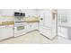 Kitchen featuring white appliances, cabinets, and granite countertops at 7501 Montibillo Pkwy, Durham, NC 27713