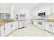 Spacious kitchen features granite counters, white cabinetry, and stainless appliances at 7501 Montibillo Pkwy, Durham, NC 27713