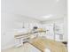 Kitchen with white cabinets and appliances, and granite countertops and floors at 7501 Montibillo Pkwy, Durham, NC 27713