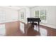 Bright living room with hardwood floors, large windows, and a grand piano at 7501 Montibillo Pkwy, Durham, NC 27713
