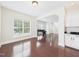 Bright living room boasts hardwood floors, large windows, and white cabinets at 7501 Montibillo Pkwy, Durham, NC 27713