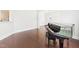 Bright living room featuring hardwood floors and a grand piano with arched doorways at 7501 Montibillo Pkwy, Durham, NC 27713