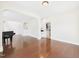 Spacious living room with hardwood floors, arched doorways, and kitchen access at 7501 Montibillo Pkwy, Durham, NC 27713