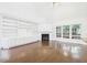 Living room featuring hardwood flooring, a fireplace, and built-in bookshelves at 7501 Montibillo Pkwy, Durham, NC 27713