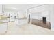 Open-concept kitchen and living room featuring an island, white cabinetry, and hardwood floors at 7501 Montibillo Pkwy, Durham, NC 27713