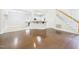 Open living area showing hardwood floors, fireplace, kitchen, and stairway at 7501 Montibillo Pkwy, Durham, NC 27713