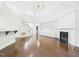 Spacious living room with a fireplace, custom built-ins, and hardwood flooring at 7501 Montibillo Pkwy, Durham, NC 27713