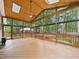 Spacious sunroom with wood ceiling, skylights, ceiling fan and large windows offering serene views at 7501 Montibillo Pkwy, Durham, NC 27713