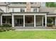 Backyard view showcases the outdoor living area, stone fireplace, and well-manicured lawn at 800 Lakestone Dr, Raleigh, NC 27609