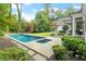 Inviting backyard with a refreshing pool, spa, and beautifully landscaped surroundings, perfect for relaxation at 800 Lakestone Dr, Raleigh, NC 27609