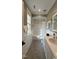 Bright bathroom with modern vanity, subway tile, and a shower-tub combination at 800 Lakestone Dr, Raleigh, NC 27609