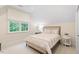 Bright bedroom features a large window, neutral decor, and a comfortable bed with stylish linens at 800 Lakestone Dr, Raleigh, NC 27609