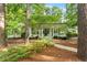 Charming home with a welcoming front porch, lush greenery, and mature trees creating a serene setting at 800 Lakestone Dr, Raleigh, NC 27609