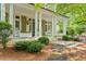Inviting front porch with classic columns, cozy rocking chairs, and planter boxes, offering a relaxing space at 800 Lakestone Dr, Raleigh, NC 27609