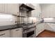 Gourmet kitchen with stainless steel oven, custom cabinets and a view from a bright window at 800 Lakestone Dr, Raleigh, NC 27609