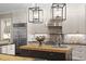 Well-appointed kitchen with stainless steel appliances, butcher block island, and stylish pendant lighting fixtures at 800 Lakestone Dr, Raleigh, NC 27609