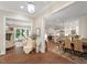 Open-concept living and dining area with hardwood floors, fireplace, and views of the outdoors at 800 Lakestone Dr, Raleigh, NC 27609
