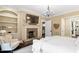 Spacious main bedroom featuring a stone fireplace, sitting area and hardwood floors at 800 Lakestone Dr, Raleigh, NC 27609
