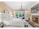 Serene main bedroom with fireplace, elegant chandelier, and access to outdoor patio provide a private retreat at 800 Lakestone Dr, Raleigh, NC 27609