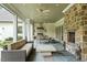 Spacious outdoor living area with stone fireplace, built-in grill, and ample seating at 800 Lakestone Dr, Raleigh, NC 27609