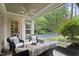 Covered porch offers comfortable seating and views of the backyard pool and landscaping at 800 Lakestone Dr, Raleigh, NC 27609