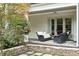Covered porch with comfortable seating and brick paved patio offers a relaxing outdoor space at 800 Lakestone Dr, Raleigh, NC 27609