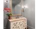 Chic powder room with stylish vanity, floral accents, and elegant lighting at 800 Lakestone Dr, Raleigh, NC 27609