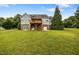 Home's backyard features a wooden deck, brick foundation, and convenient garage access at 100 Virginia Lee Ln, Efland, NC 27243