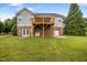 Rear view shows a wooden deck supported by brick, with easy garage and yard access at 100 Virginia Lee Ln, Efland, NC 27243