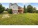 The house features a spacious backyard, highlighted by a wooden deck and brick accents at 100 Virginia Lee Ln, Efland, NC 27243