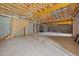 Unfinished basement space with exposed ceiling, concrete floor and cinder block walls at 100 Virginia Lee Ln, Efland, NC 27243
