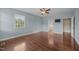 Primary bedroom featuring wood floors, a large window, and an ensuite bathroom at 100 Virginia Lee Ln, Efland, NC 27243