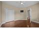 Neutral bedroom with hardwood flooring, closet and a ceiling fan at 100 Virginia Lee Ln, Efland, NC 27243