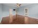 Bright primary bedroom with wood floors, a ceiling fan, and access to a private balcony at 100 Virginia Lee Ln, Efland, NC 27243