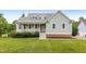 Charming home featuring a welcoming front porch and a beautifully maintained lawn at 100 Virginia Lee Ln, Efland, NC 27243