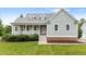 Charming home featuring a welcoming front porch and a beautifully maintained lawn at 100 Virginia Lee Ln, Efland, NC 27243