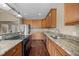 Open kitchen featuring granite countertops, wooden cabinets, and stainless steel appliances at 100 Virginia Lee Ln, Efland, NC 27243