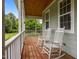 Inviting porch with wooden floors and rocking chairs, perfect for relaxing outdoors at 100 Virginia Lee Ln, Efland, NC 27243