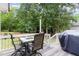 Spacious deck with outdoor dining set, barbecue grill, string lights, and fenced yard at 1001 Kingsway Dr, Apex, NC 27502